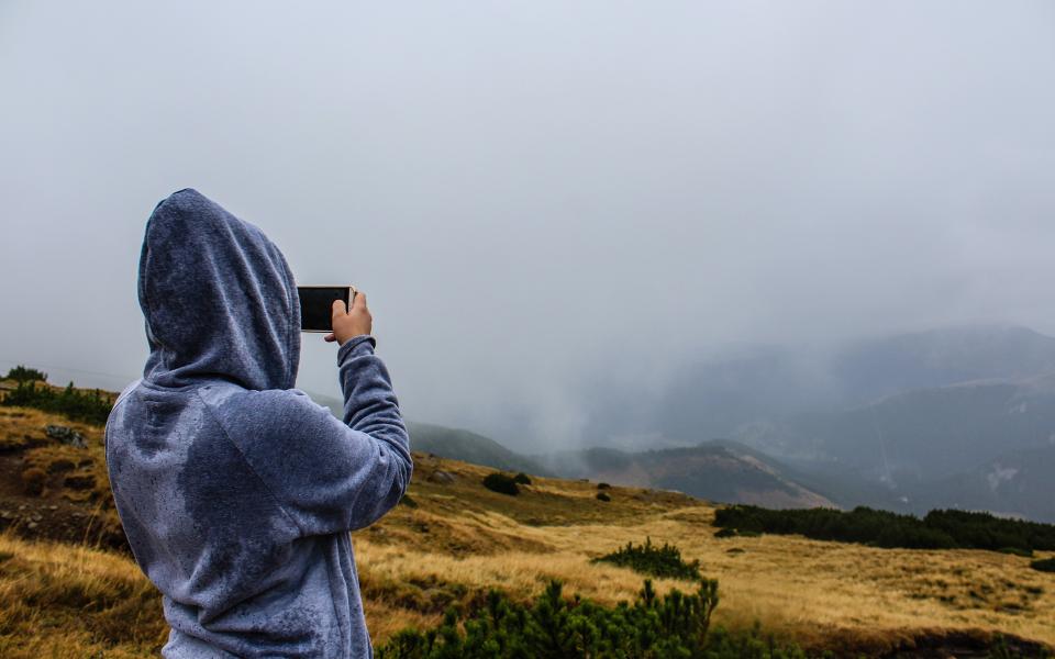 A person wearing a comfortable hoodie outdoors